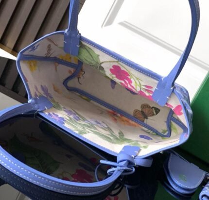 Goyard Mini Anjou Bag - Blue with a floral lining.