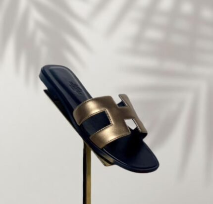 The Hermès Oran Sandal in metallic Dore Foncé